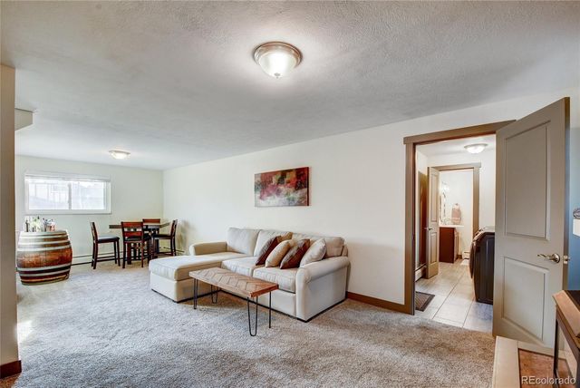 a living room with furniture and a lamp