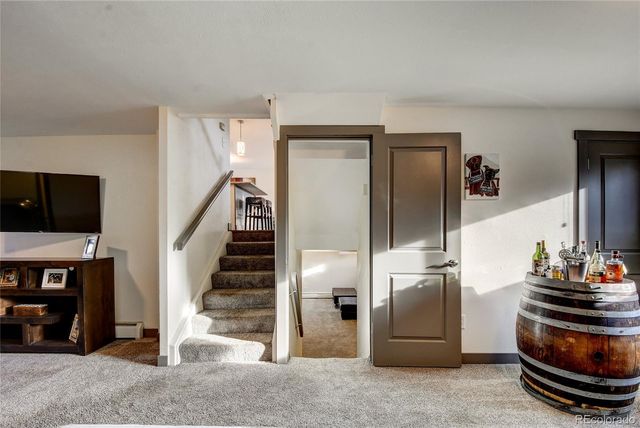 a view of a livingroom with furniture and an empty room