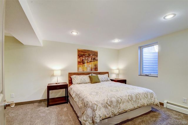 a bedroom with a bed and a night stand