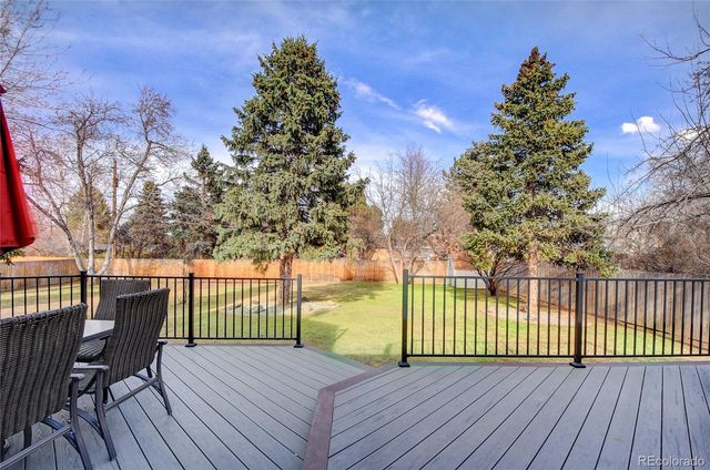 a view of a deck with wooden floor and fence