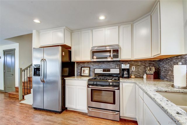 a kitchen with cabinets stainless steel appliances and a counter space