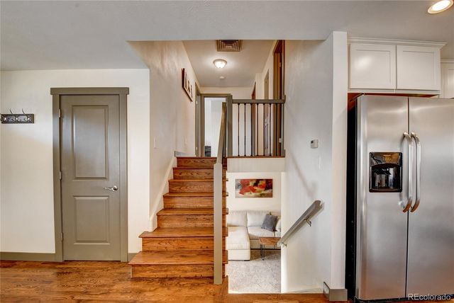 a view of entryway with furniture and wooden floor