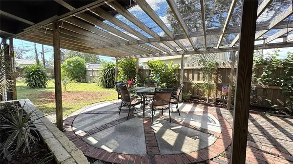 a view of a patio with a dining table and chairs