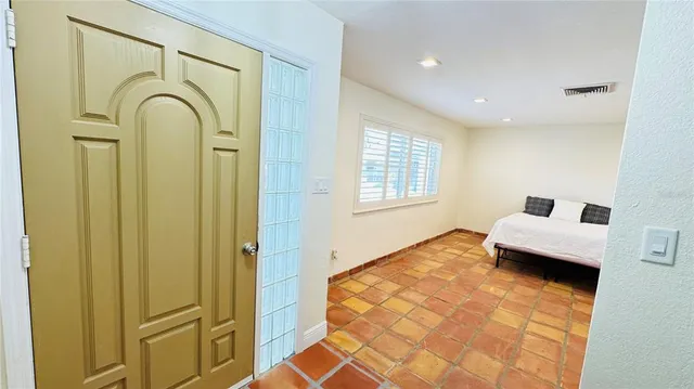 a spacious bedroom with a large bed and a window