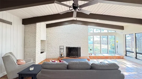 a living room with furniture tv and a fireplace