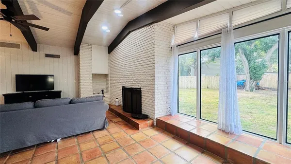 a living room with furniture and a ceiling fan