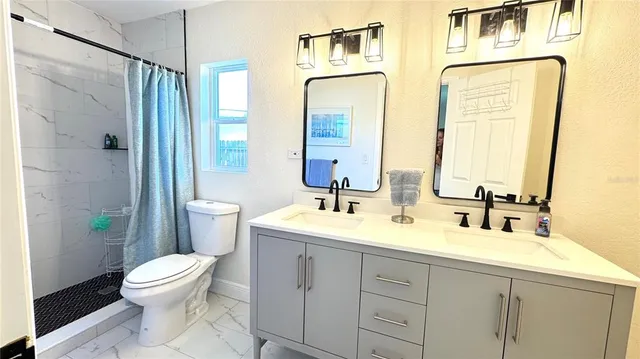 a bathroom with a double vanity sink and mirror