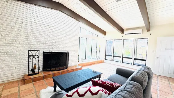 a living room with furniture and a mirror