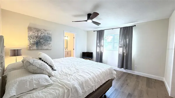 a bedroom with a bed and a large mirror
