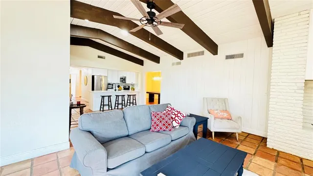 a living room with furniture and a ceiling fan
