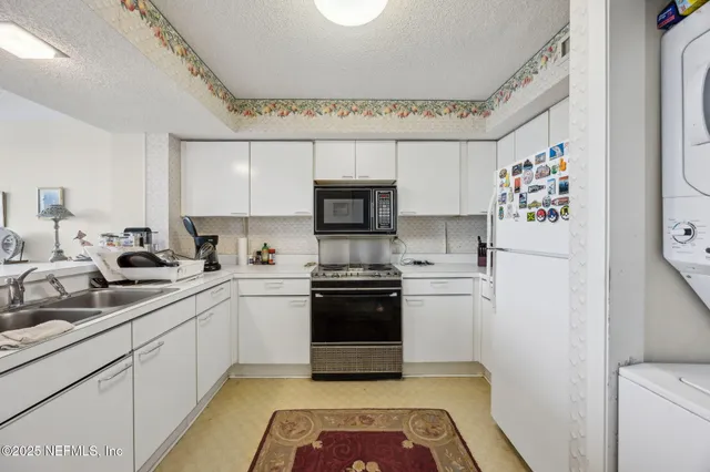 a kitchen with a sink stainless steel appliances and cabinets