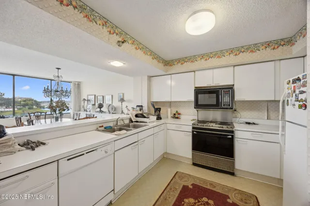 a kitchen with stainless steel appliances granite countertop a sink and cabinets