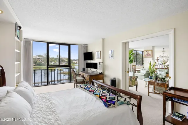 a bedroom with furniture and a flat screen tv