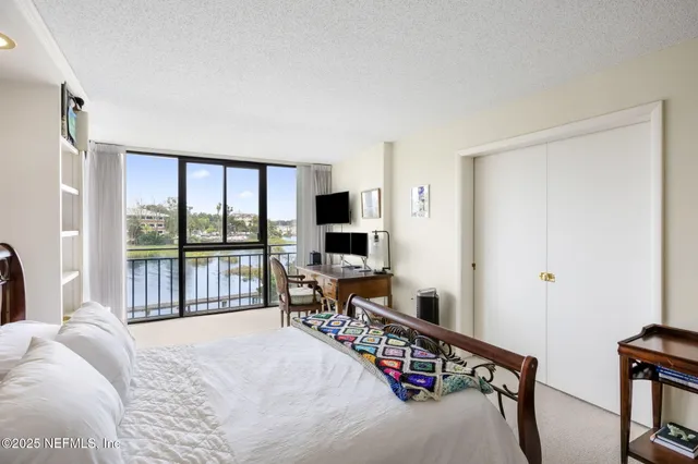 a bedroom with furniture and a flat screen tv
