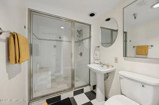 a bathroom with a sink toilet and shower