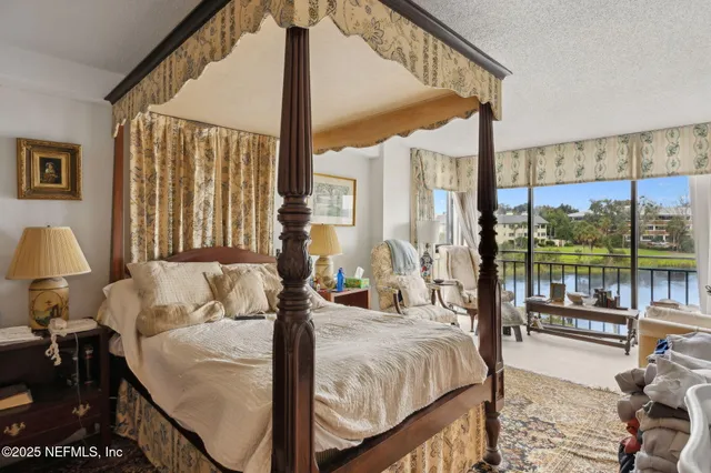 a bedroom with a bed and a large window