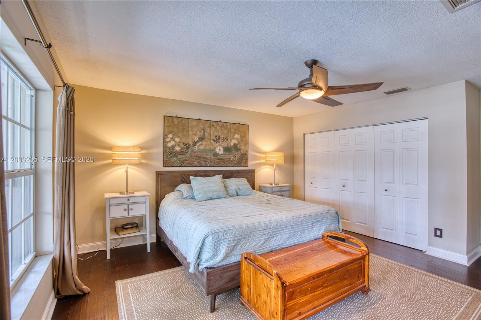 16078 Mellen Lane Jupiter, FL 33478 - Photo 19 of 57 a bedroom with a bed and a lamp with the bathroom