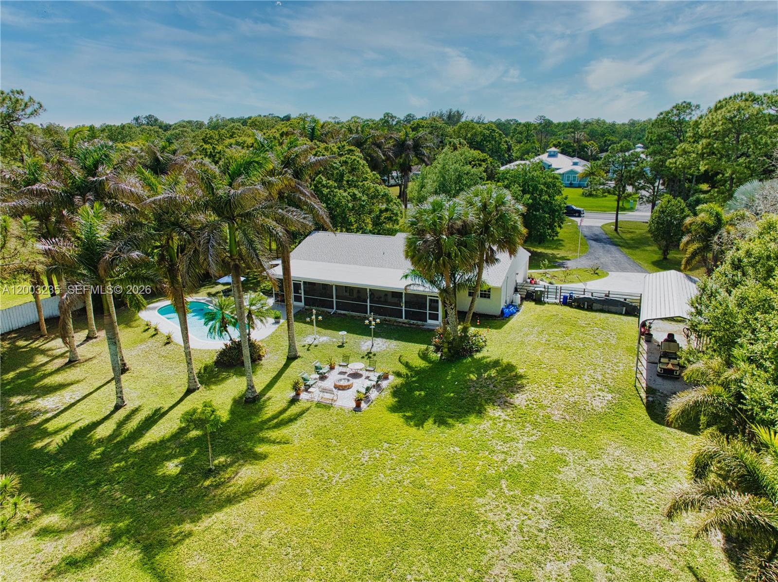 16078 Mellen Lane Jupiter, FL 33478 - Photo 2 of 57 a view of a swimming pool with a garden