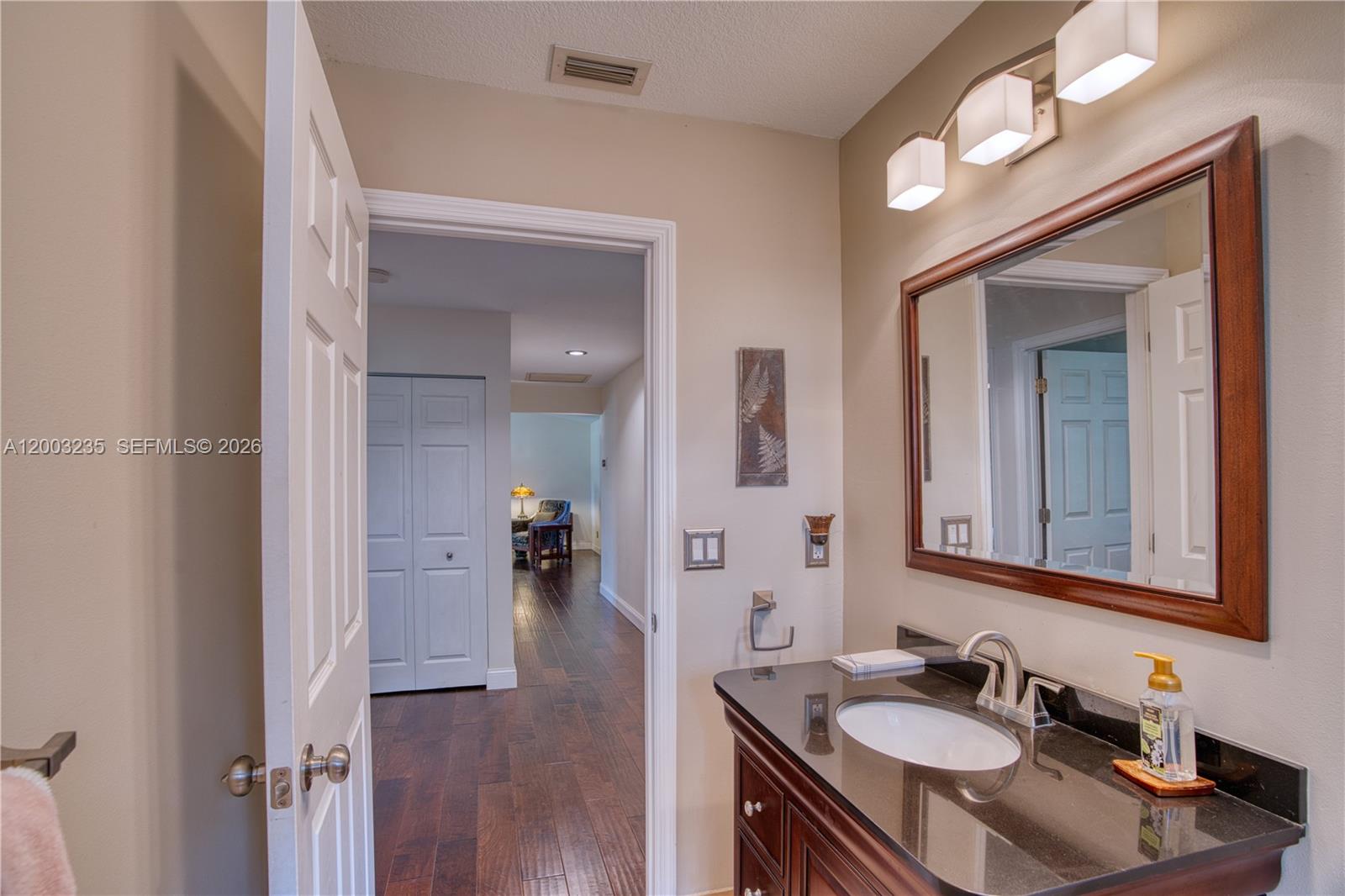 16078 Mellen Lane Jupiter, FL 33478 - Photo 29 of 57 a bathroom with a sink double vanity and a mirror