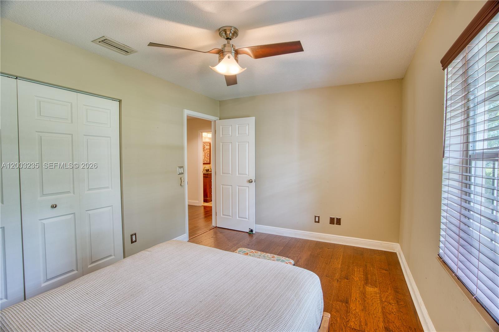 16078 Mellen Lane Jupiter, FL 33478 - Photo 30 of 57 a bedroom with a bed and a window