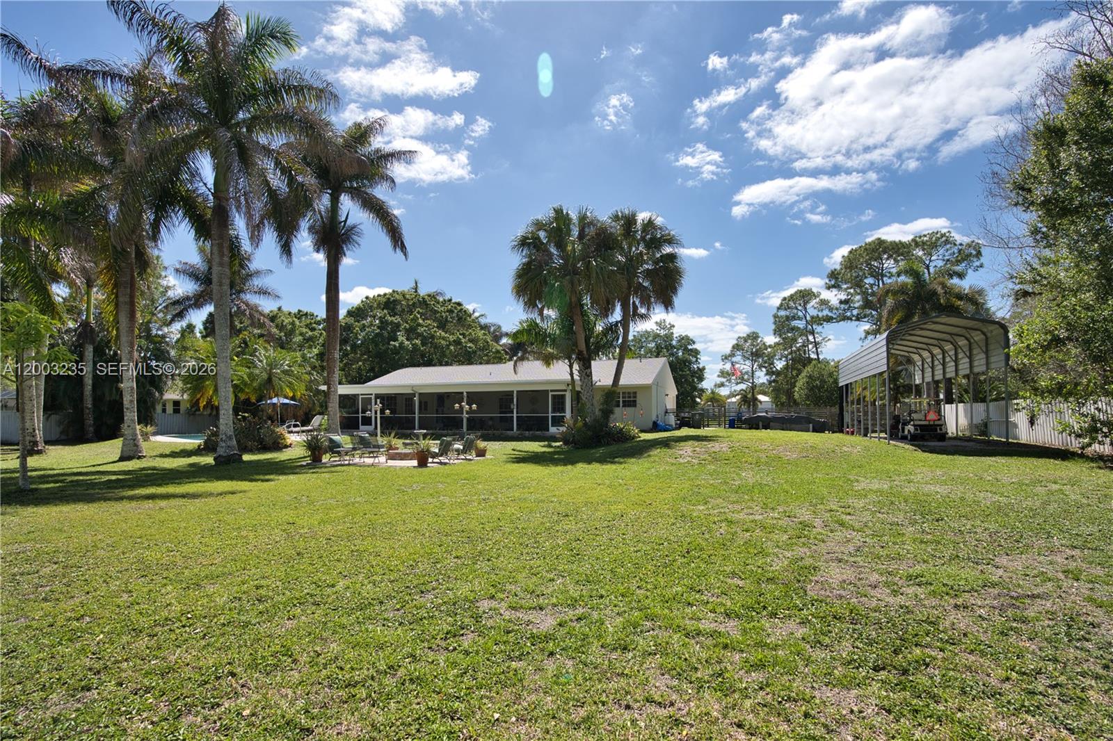 16078 Mellen Lane Jupiter, FL 33478 - Photo 41 of 57 a view of a house with a yard and basketball ground