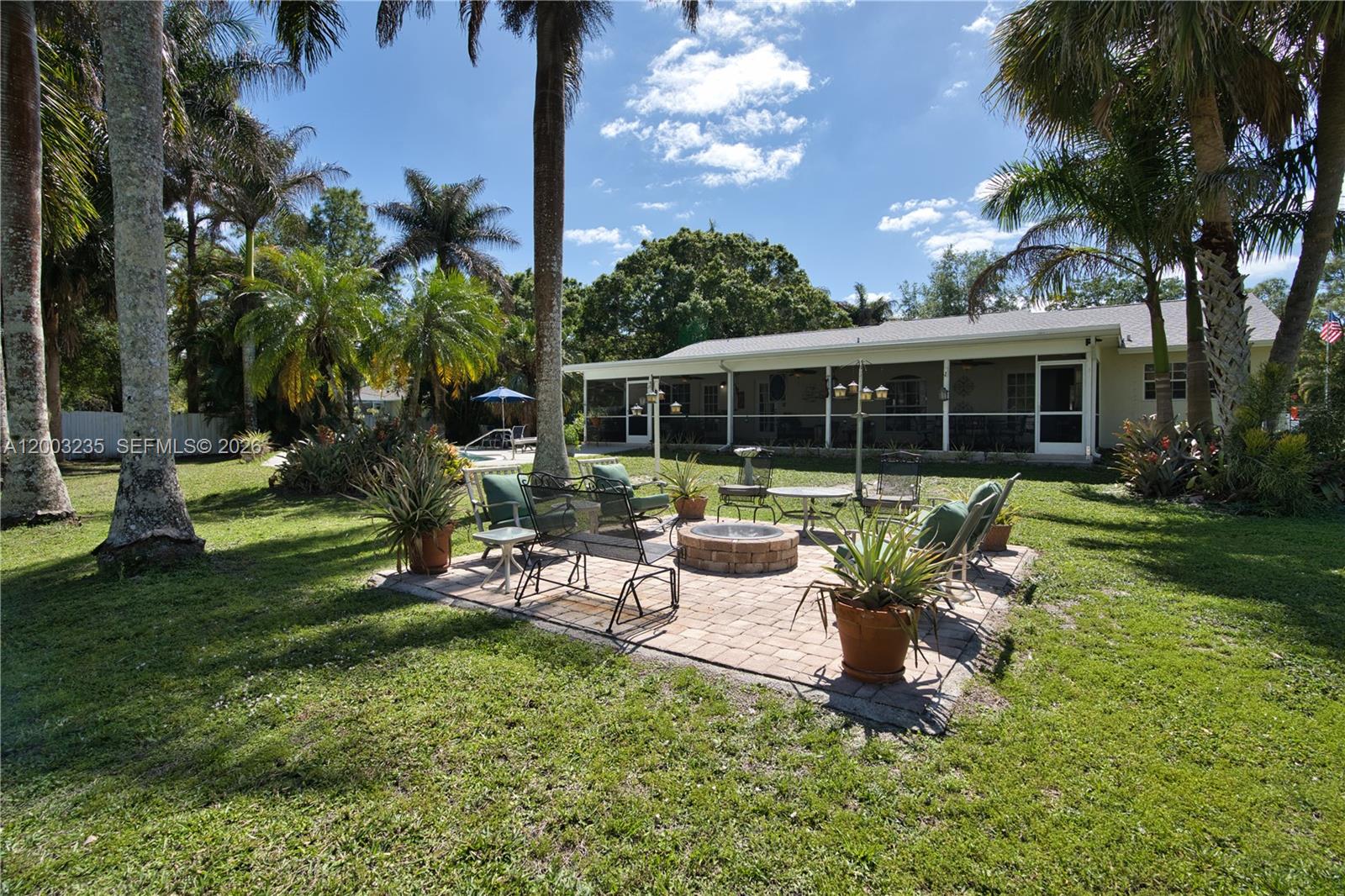 16078 Mellen Lane Jupiter, FL 33478 - Photo 43 of 57 a view of a house with backyard porch and sitting area