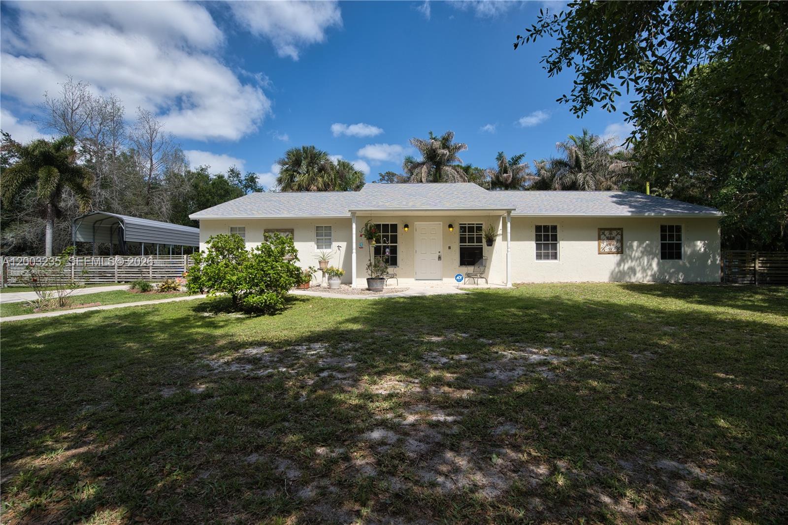 16078 Mellen Lane Jupiter, FL 33478 - Photo 47 of 57 a front view of a house with a yard