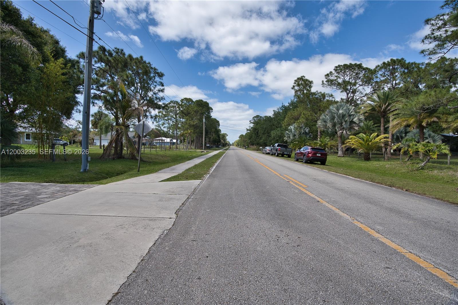 16078 Mellen Lane Jupiter, FL 33478 - Photo 52 of 57 a view of a street with a building in the background