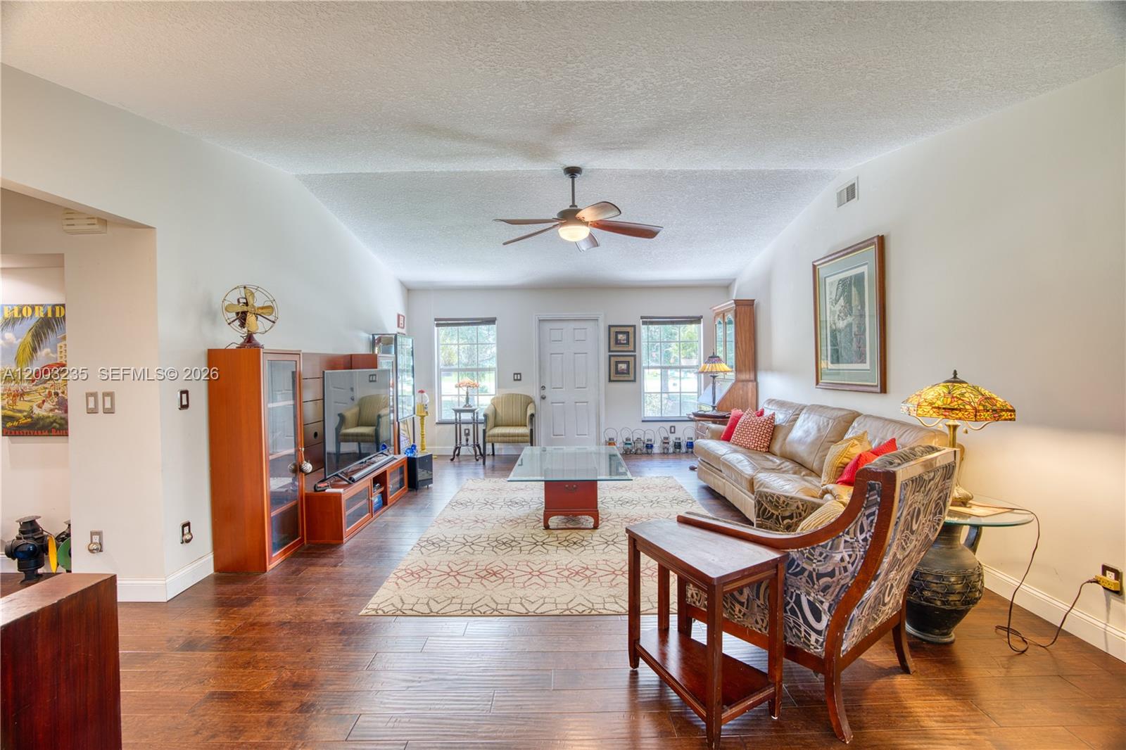 16078 Mellen Lane Jupiter, FL 33478 - Photo 6 of 57 a living room with furniture and wooden floor
