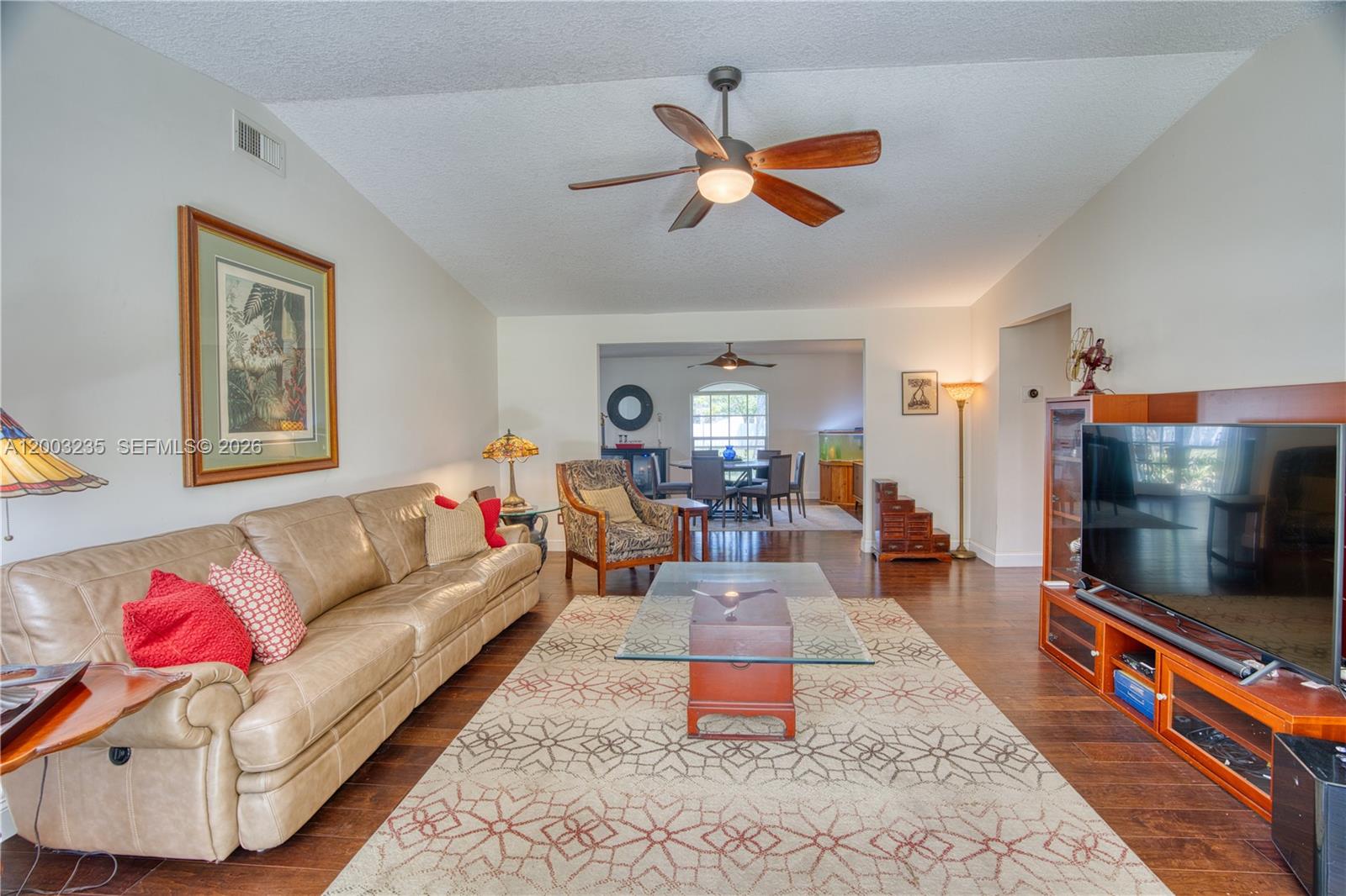 16078 Mellen Lane Jupiter, FL 33478 - Photo 7 of 57 a living room with furniture and a flat screen tv