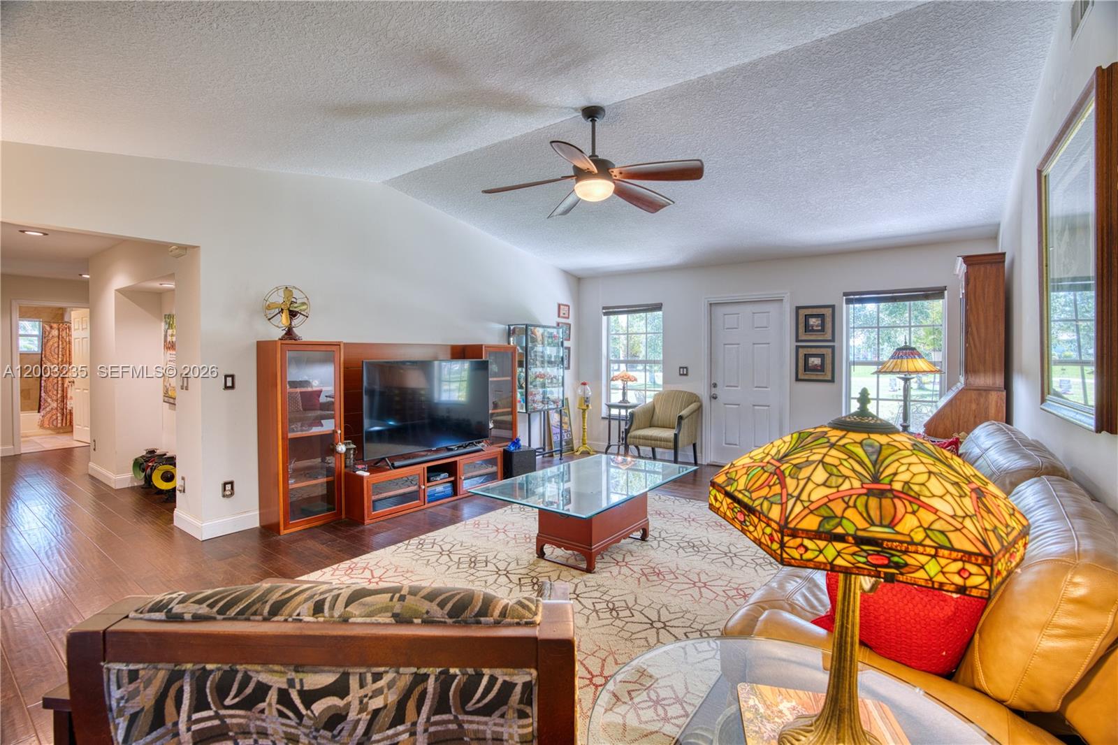 16078 Mellen Lane Jupiter, FL 33478 - Photo 8 of 57 a living room with furniture and a flat screen tv