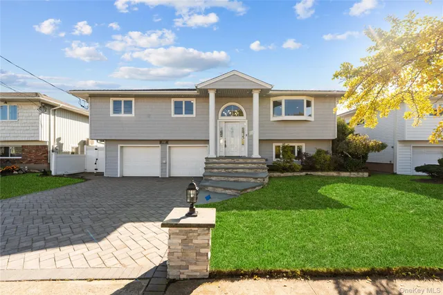 a front view of a house with a yard and garage