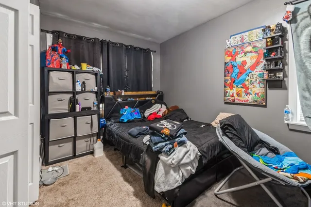 a bedroom with furniture cabinets and window