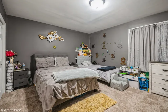 a bedroom with bed and a chandelier