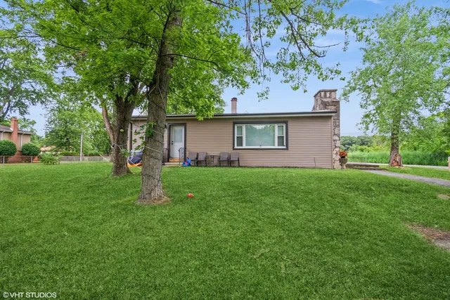 a front view of house with a garden