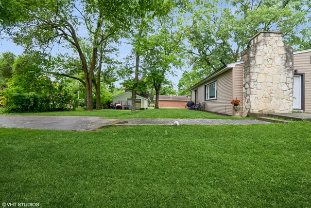 a view of house with backyard