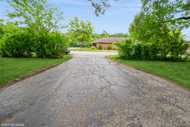 a view of a garden with a building in the background