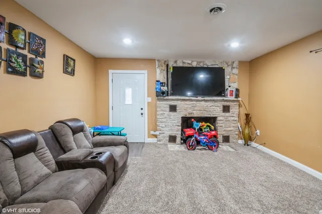 a living room with furniture and a fireplace