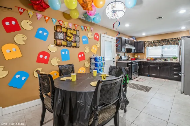 a view of a dining room with furniture and a kitchen