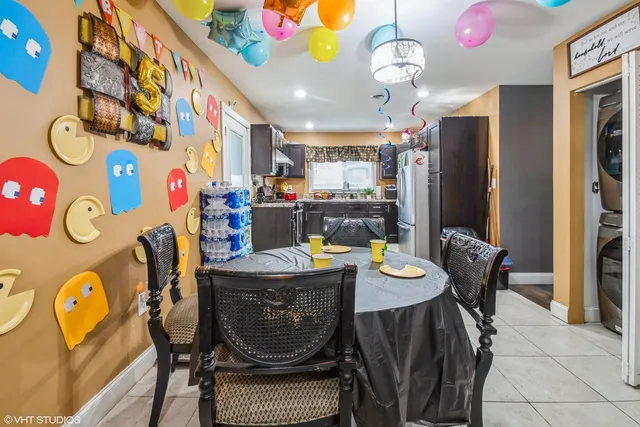 a view of a dining room with furniture and chandelier
