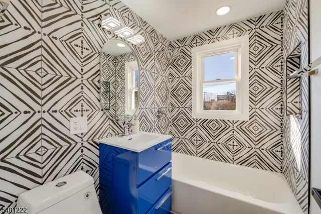 a bathroom with a sink a mirror and a bathtub