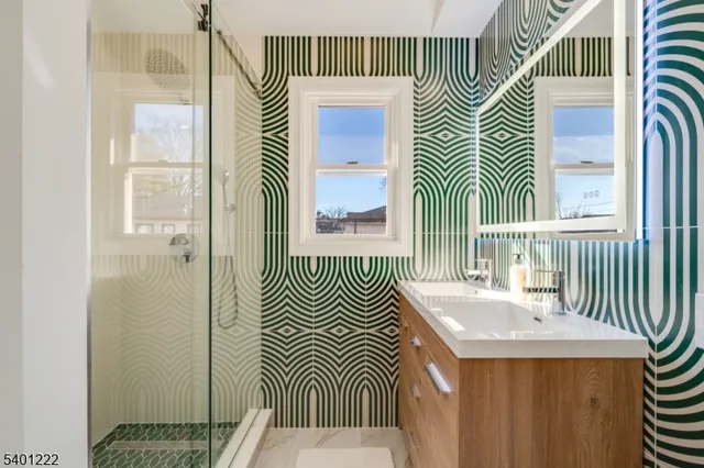 a bathroom with a sink a mirror and a shower