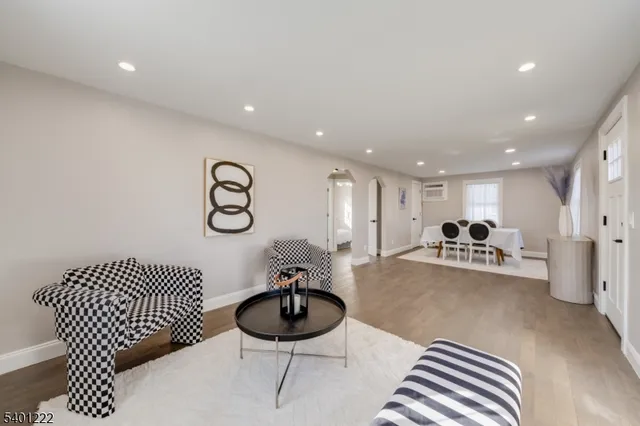 a living room with furniture and a chandelier
