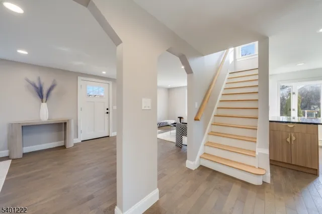 a view of entryway with wooden floor and stairs