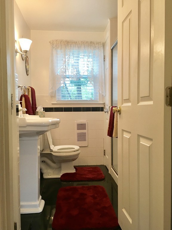 76 Rinaldo Road Weymouth, MA 02191 - Photo 12 of 23 a bathroom with a sink a toilet a window and shower