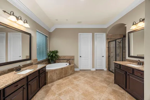 a spacious bathroom with a granite countertop sink and a large mirror