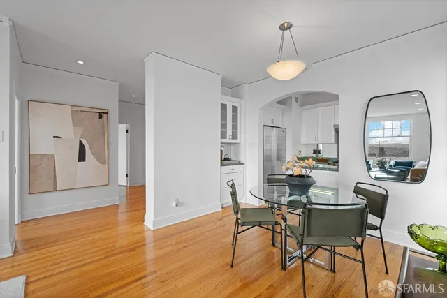 a living room with furniture a large window and gym equipment