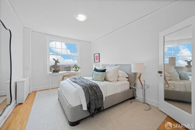 a bedroom with a bed and a window