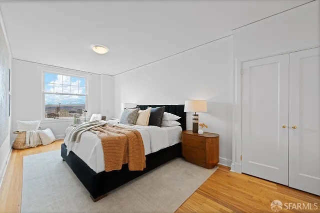 a bed sitting in a bedroom next to a window