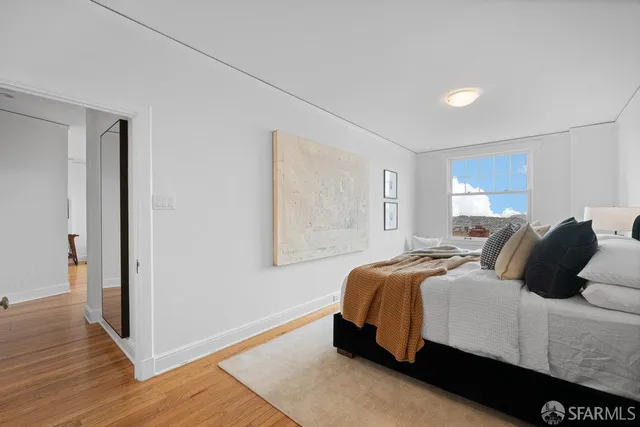 a bed room with a bed and a night stand